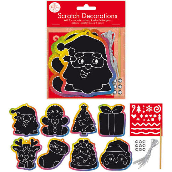 Scratch Decorations kit in retail packaging with eight black scratch-off holiday shapes outlined in rainbow borders, plus ribbon, gems, and a small red pattern sheet on a white background.